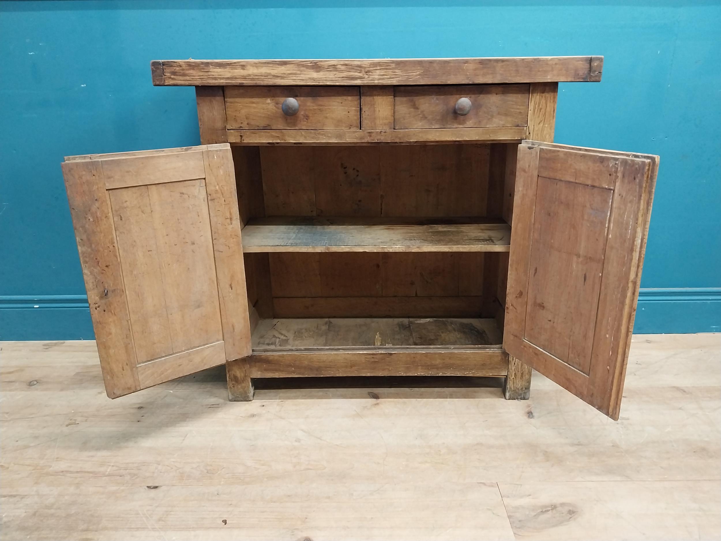 Early 20th C. oak and pine cupboard with two long doors over two short drawers on square feet. {80 - Image 8 of 9
