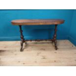 19th C. mahogany oval side table raised carved supports, single stretcher and four outswept feet {70