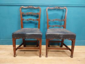 Near pair of Georgian mahogany side chairs with leather upholstered seats, raised on square legs
