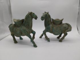 Pair of oriental bronze horses. {27 cm H x 30 cm W x 14 cm D}.