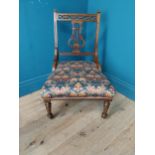 Edwardian mahogany nursing chair with upholstered seat raised on turned legs and castors {76 cm H
