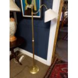 Edwardian brass floor lamp with cloth shade {150 cm H x 42 cm W x 26 cm D}.