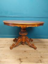 Walnut centre table raised on carved column and four outswept feet in the William IV style {84 cm