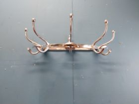 Chrome coat rack {19 cm H x 65 cm W x 34 cm D}.