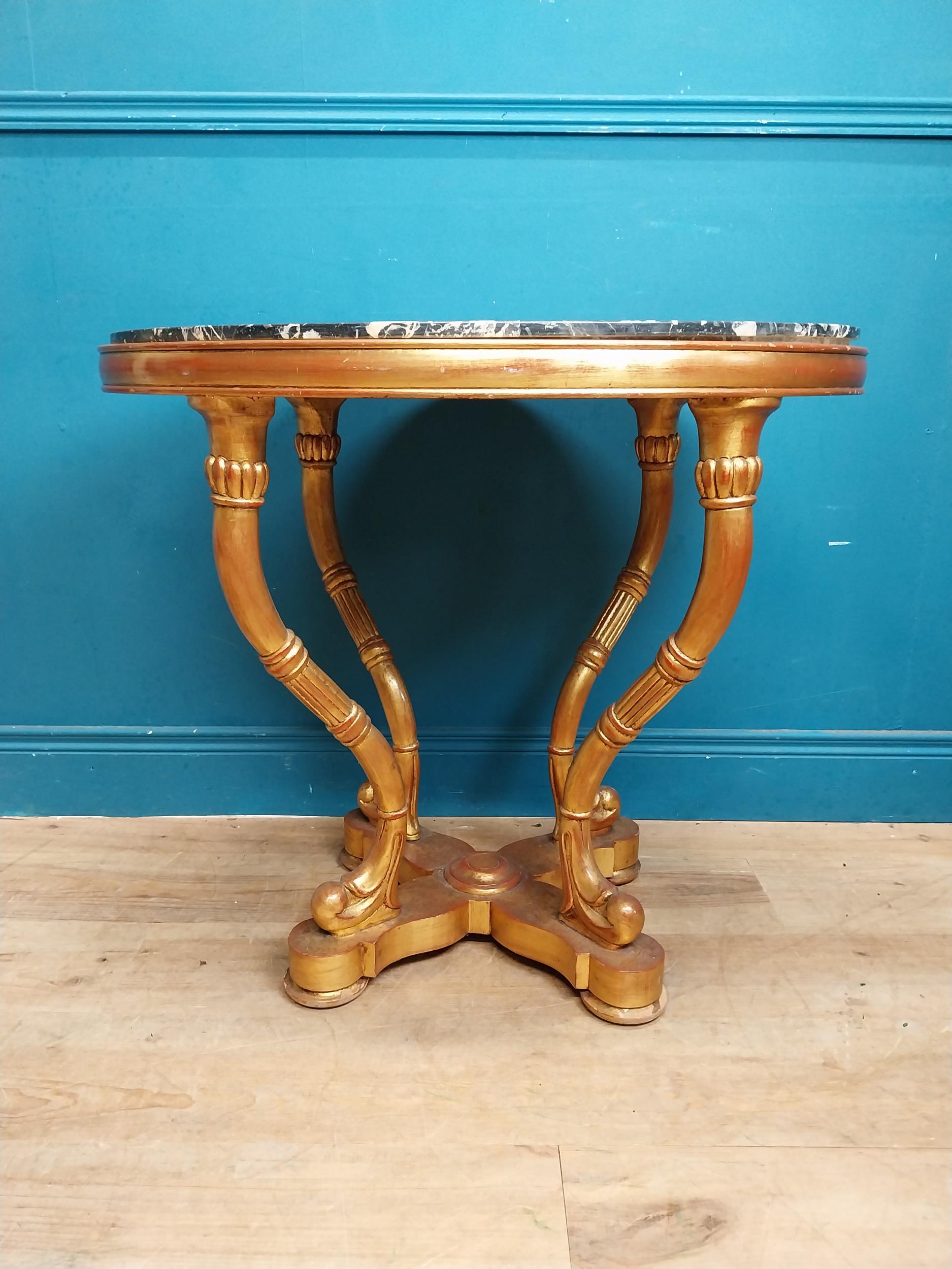 Decorative giltwood centre table with marble top raised on four shaped legs and x-frame platform