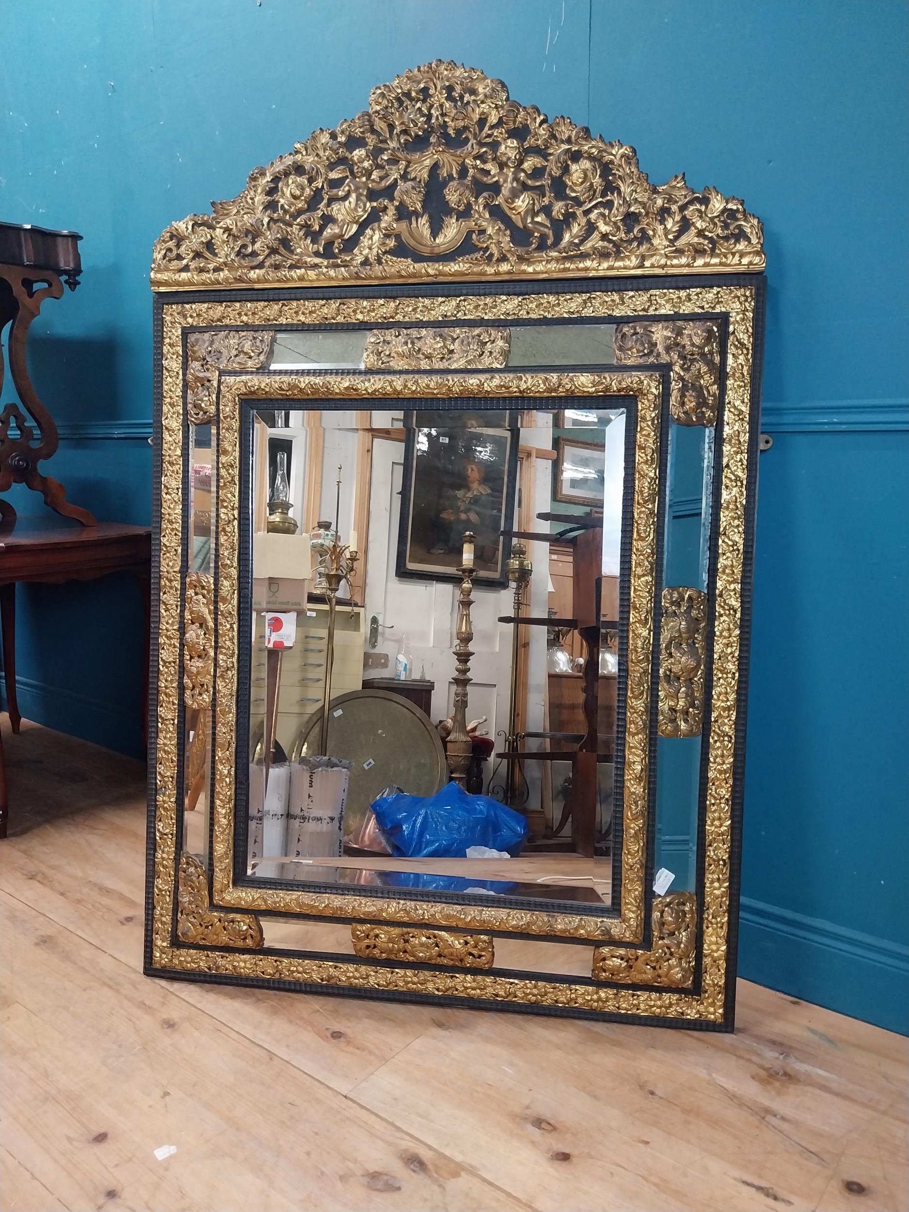 19th C. French brass and ebonised cushion mirror surmounted with cherub and flora and foliage - Image 2 of 8