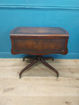Walnut drop leaf centre table with leather top raised on carved column, four outswept feet and