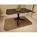 Ebonised centre table with single column raised on three legs and brass feet in the Regency