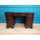 Mahogany pedestal desk with tooled leather top and eight short drawers and single drawer in frieze