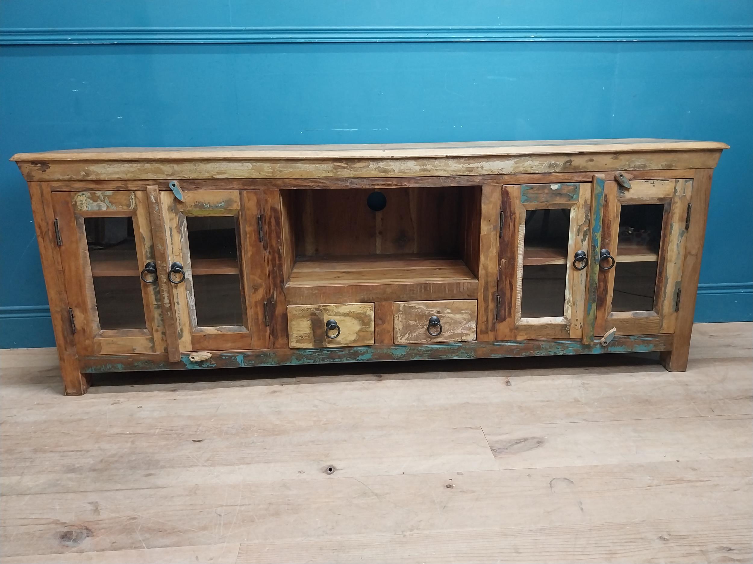 Decorative wooden side cabinet with metal mounts and handles with four glazed doors, two short