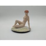 Early 20th C. Czech Republic figurine of reclining Nude. {23 cm H x 23 cm W x 16 cm D}.