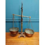 Early 20th C. brass and cast iron shop scales. {54 cm H x 43 cm W x 19 cm D}.