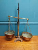 Early 20th C. brass and cast iron shop scales. {54 cm H x 43 cm W x 19 cm D}.