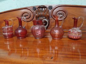Five 19th C. ruby glass jugs. {19 cm, 23 cm, 22 cm and 20 cm H}.