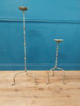 Two wrought iron floor candle sticks {112 cm H and 72 cm H}.