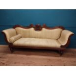 William IV carved mahogany and upholstered three seater sofa with eagle decoration raised on