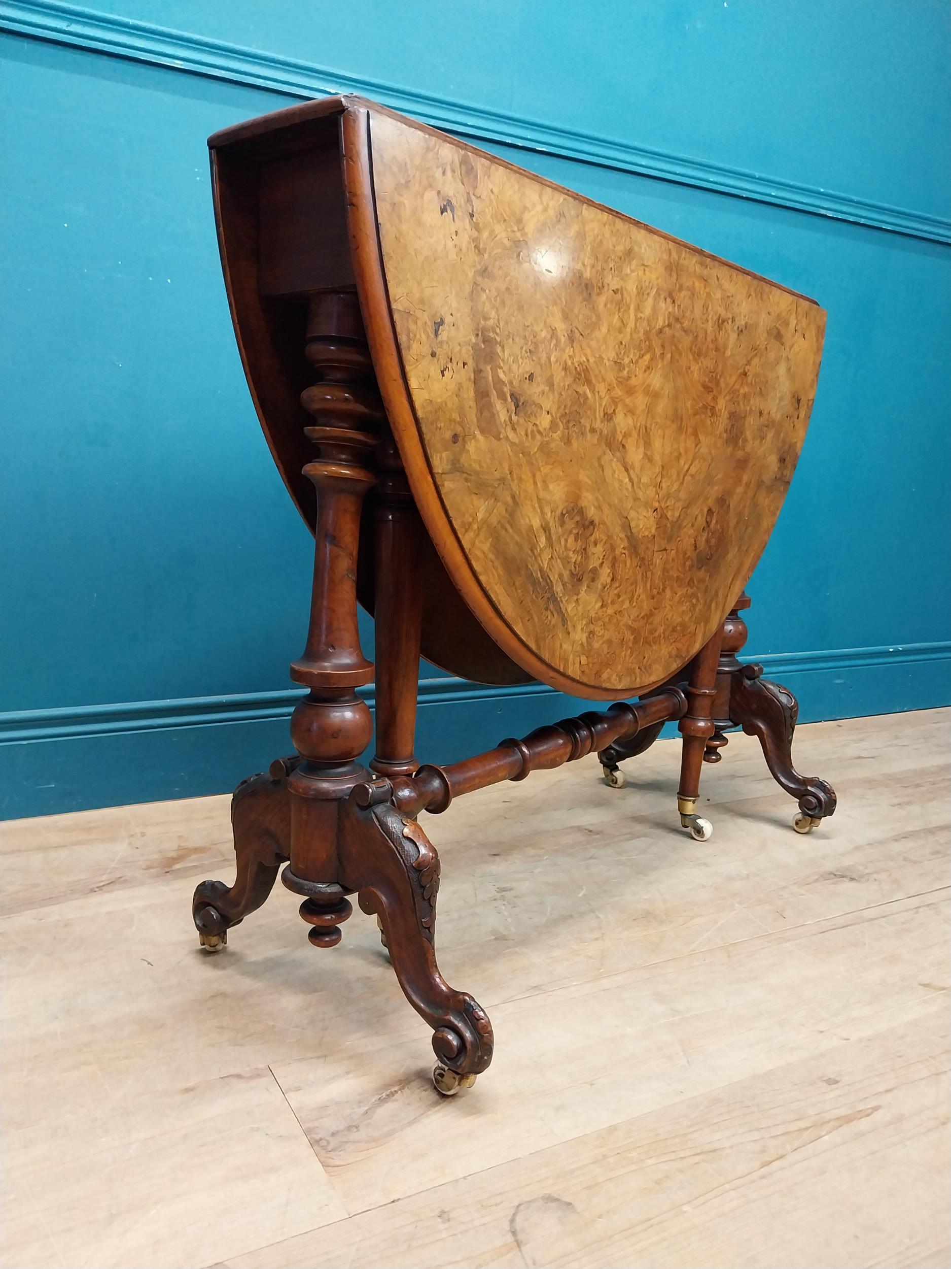 19th C. burr walnut Sutherland table with turned legs raised on arched feet with castors. {73 cm H x