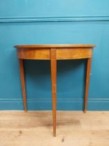 Mahogany and satinwood demi lune table on three tapered feet. {74 cm H x 76 cm W x 41 cm}.