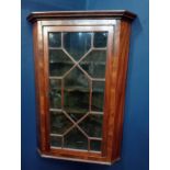 Walnut veneered hanging corner cabinet with astral glazed door {H 107cm x W 68cm x D 43cm }.