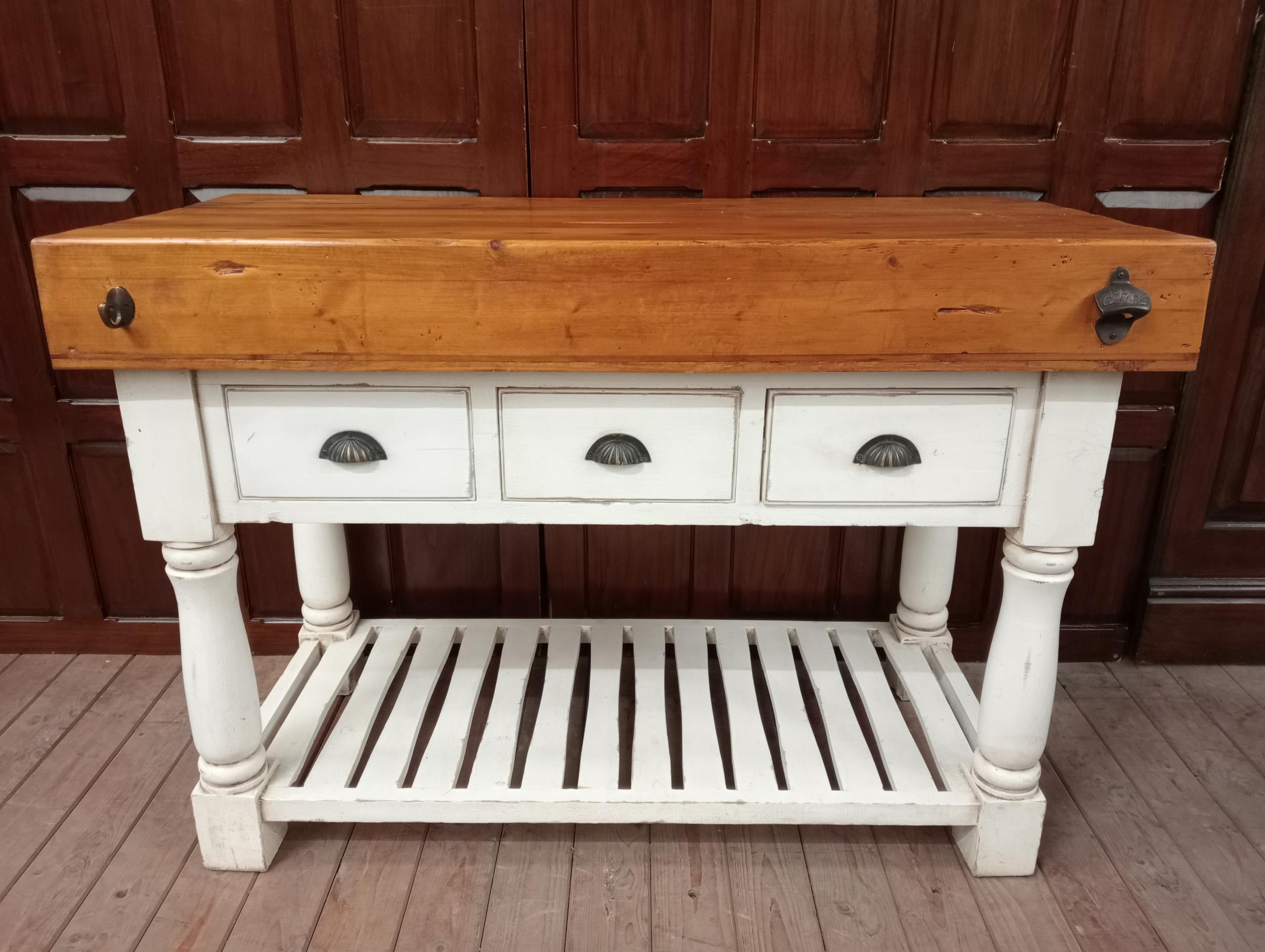 Butchers block with three short drawers raised on turned legs {H 90cm x W 130cm x D 59cm }.