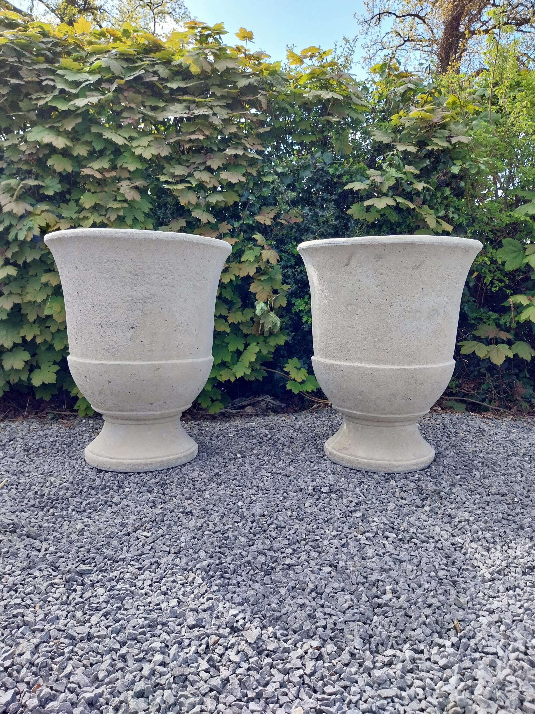 Pair of moulded sandstone circular urns {74 cm H x 59 cm Dia.}.