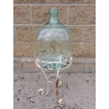 Glass carboy raised on metal stand {H 90cm x Dia 35cm }. (NOT AVAILABLE TO VIEW IN PERSON)