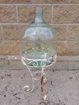 Glass carboy raised on metal stand {H 90cm x Dia 35cm }. (NOT AVAILABLE TO VIEW IN PERSON)