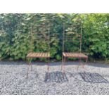 Pair of wrought iron high back garden chairs {114 cm H x 44 cm W x 44 cm D}.