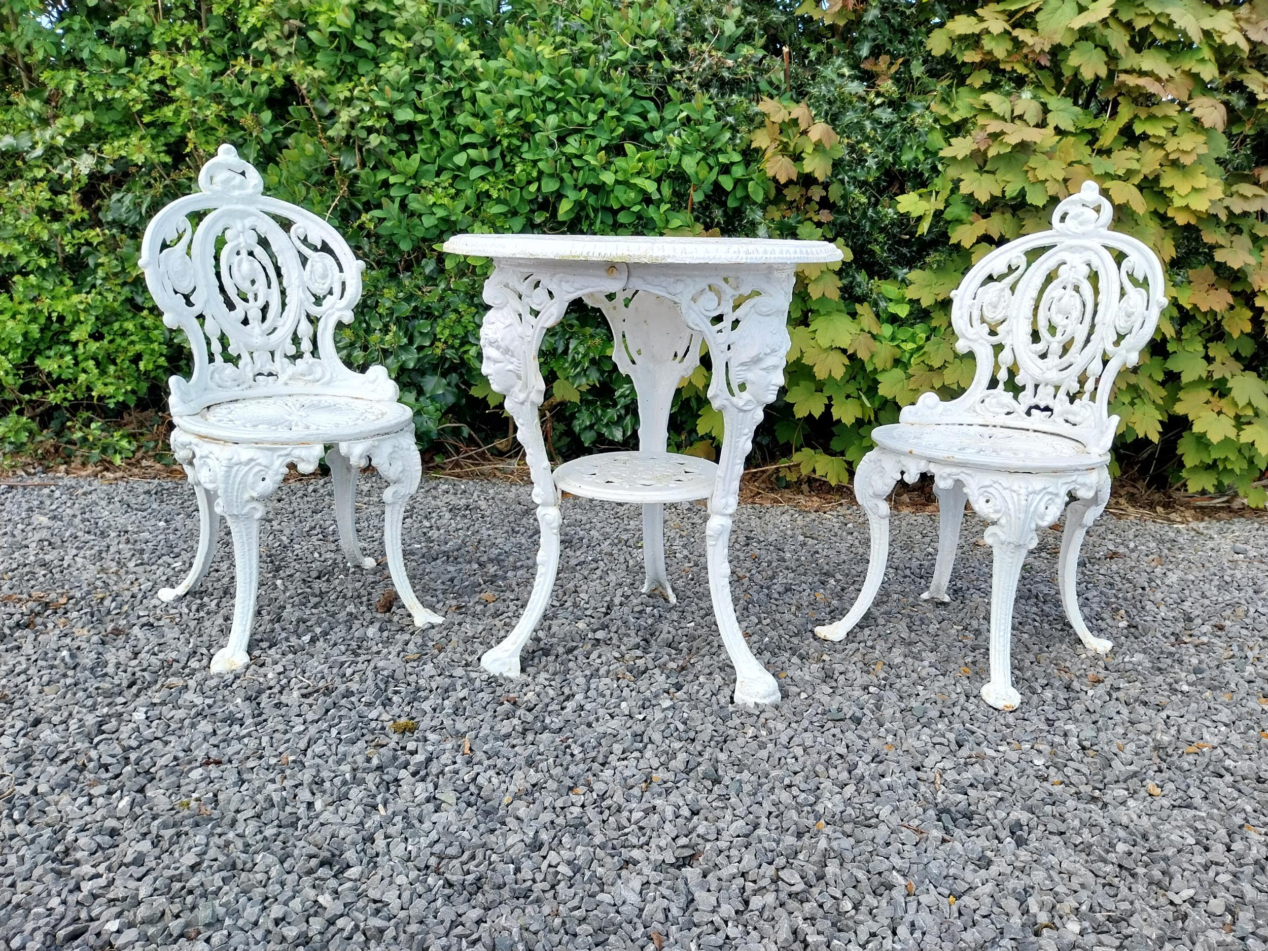 19th C. cast iron garden table with two matching chairs {Tbl. 68 cm H x 59 cm Dia. and Chairs 83