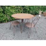 Wrought iron garden table with four matching chais.