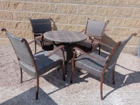 Rattan table and four rattan armchairs {Table H 70cm Dia 75cm Chairs H 86cm x W 57cm x D 52cm }. (