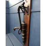 Ornate cast iron water pump mounted on wooden board{H 133cm x W 36cm x D 41cm }. (NOT AVAILABLE TO