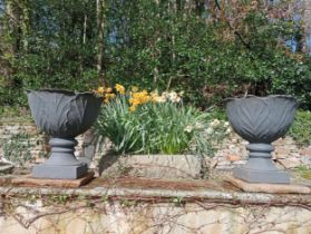 Pair of cast iron urns raised on sandstone pedestal {H 67cm x Dia 60cm }. (NOT AVAILABLE TO VIEW