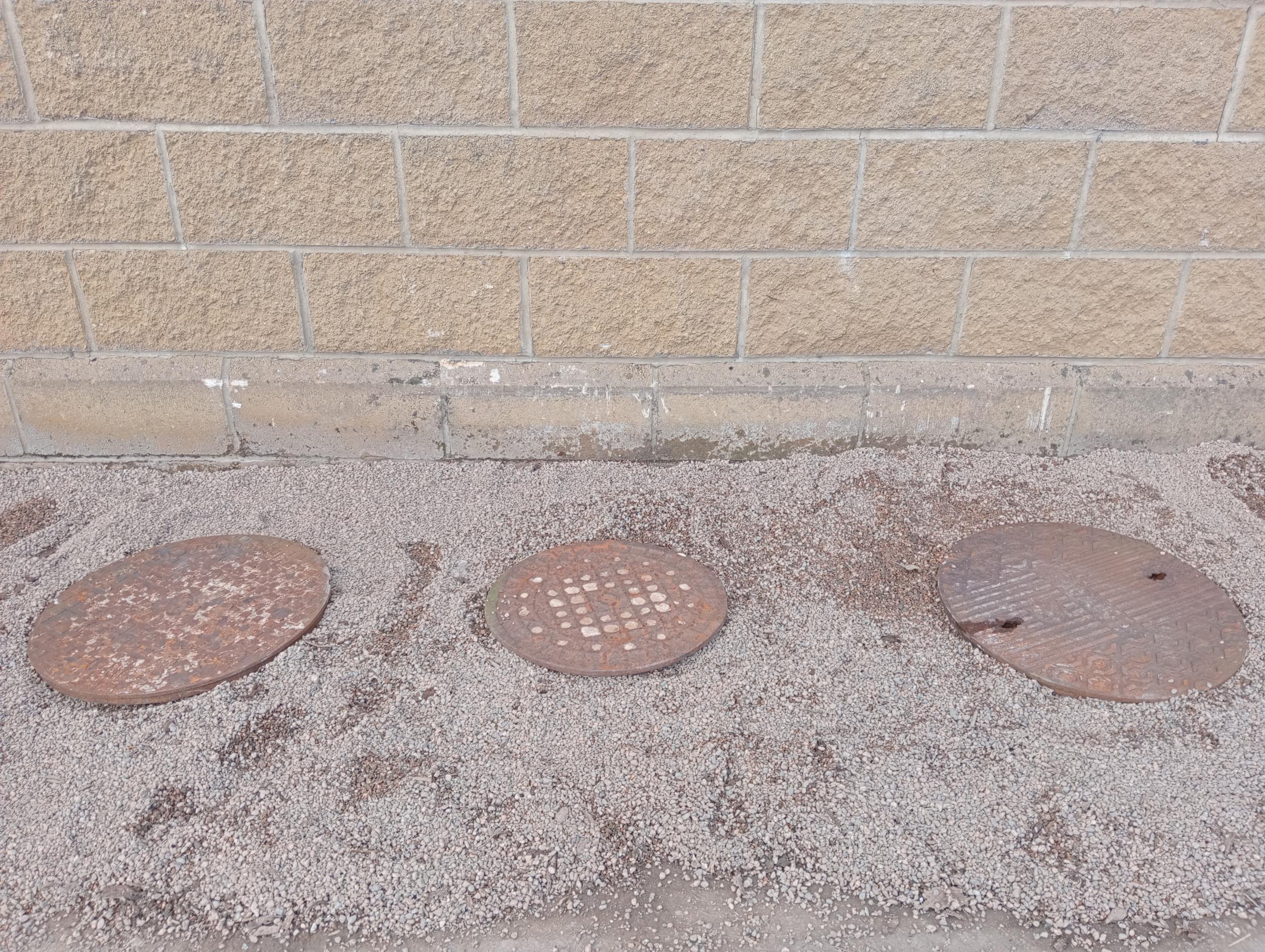 Three cast iron manhole covers {two covers Dia 50cm x One at 30 cm Dia.}. (NOT AVAILABLE TO VIEW