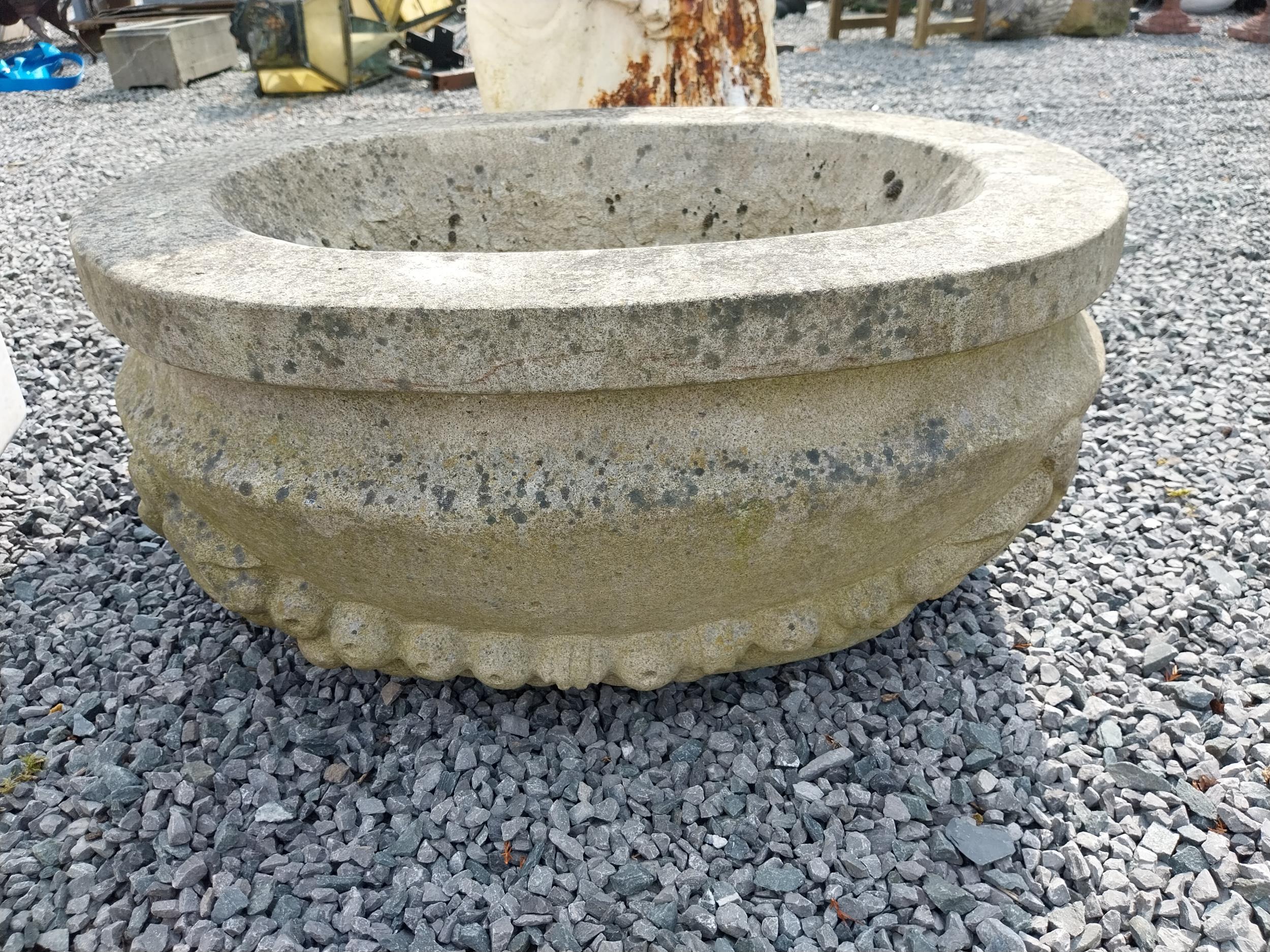 Good quality carved sandstone planter decorated with swags {37 cm H x 80 cm W x 61 cm D}.