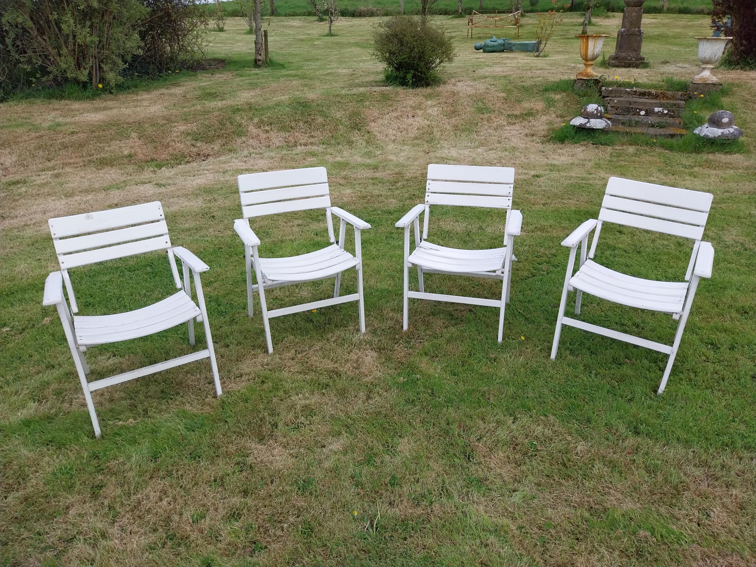 Set of four painted wooden folding garden armchairs {85 cm H x 66 cm W x 54 cm D}.