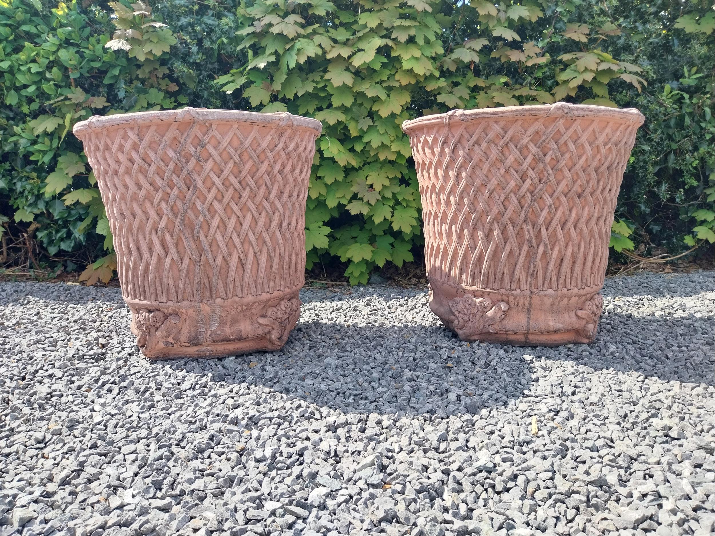 Pair of moulded terracotta circular lattice urns {53 cm H x 54 cm Dia.}.