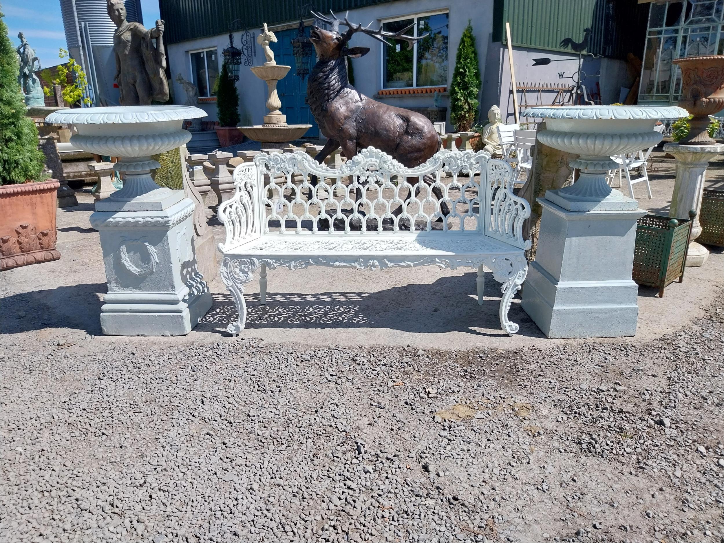 Pair of good quality early 19th C. cast iron urns raised on one buff terracotta pedestal decorated