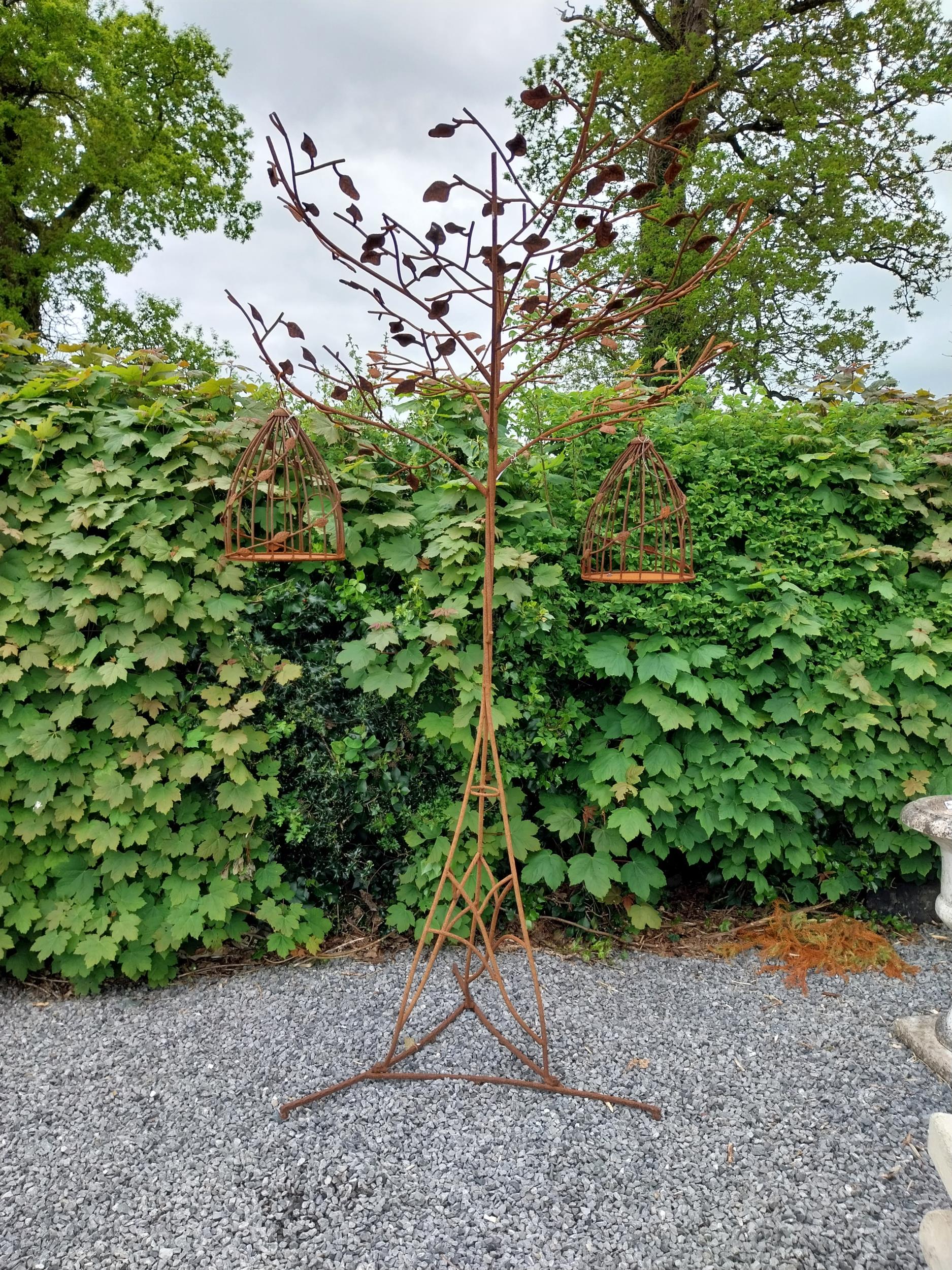 Decorative wrought iron bird feeder in the form of a tree and two hanging bird cages {224 cm H x 135