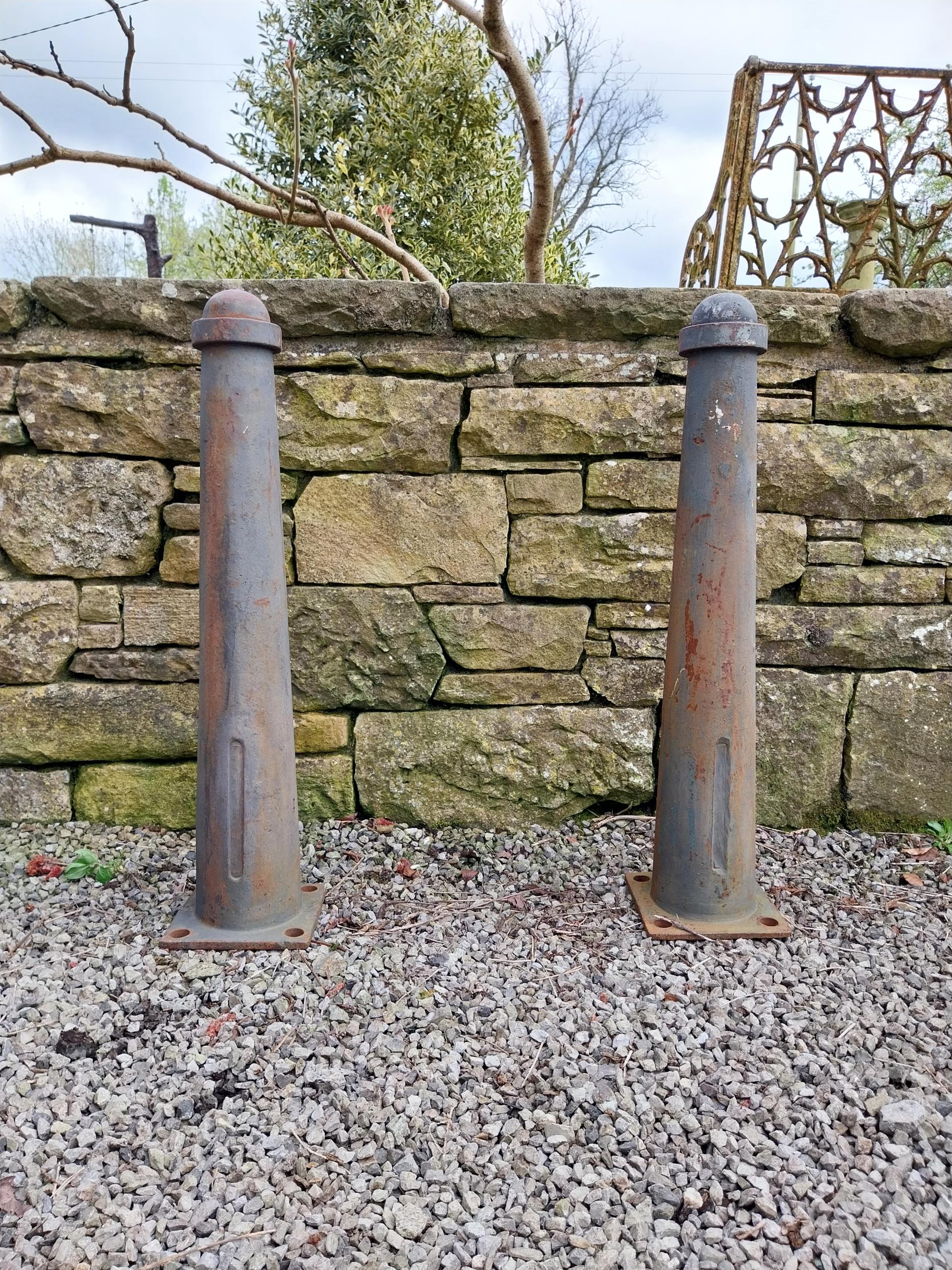 Pair of cast iron bollards {88 cm H x 20 cm W x 21 cm D}.