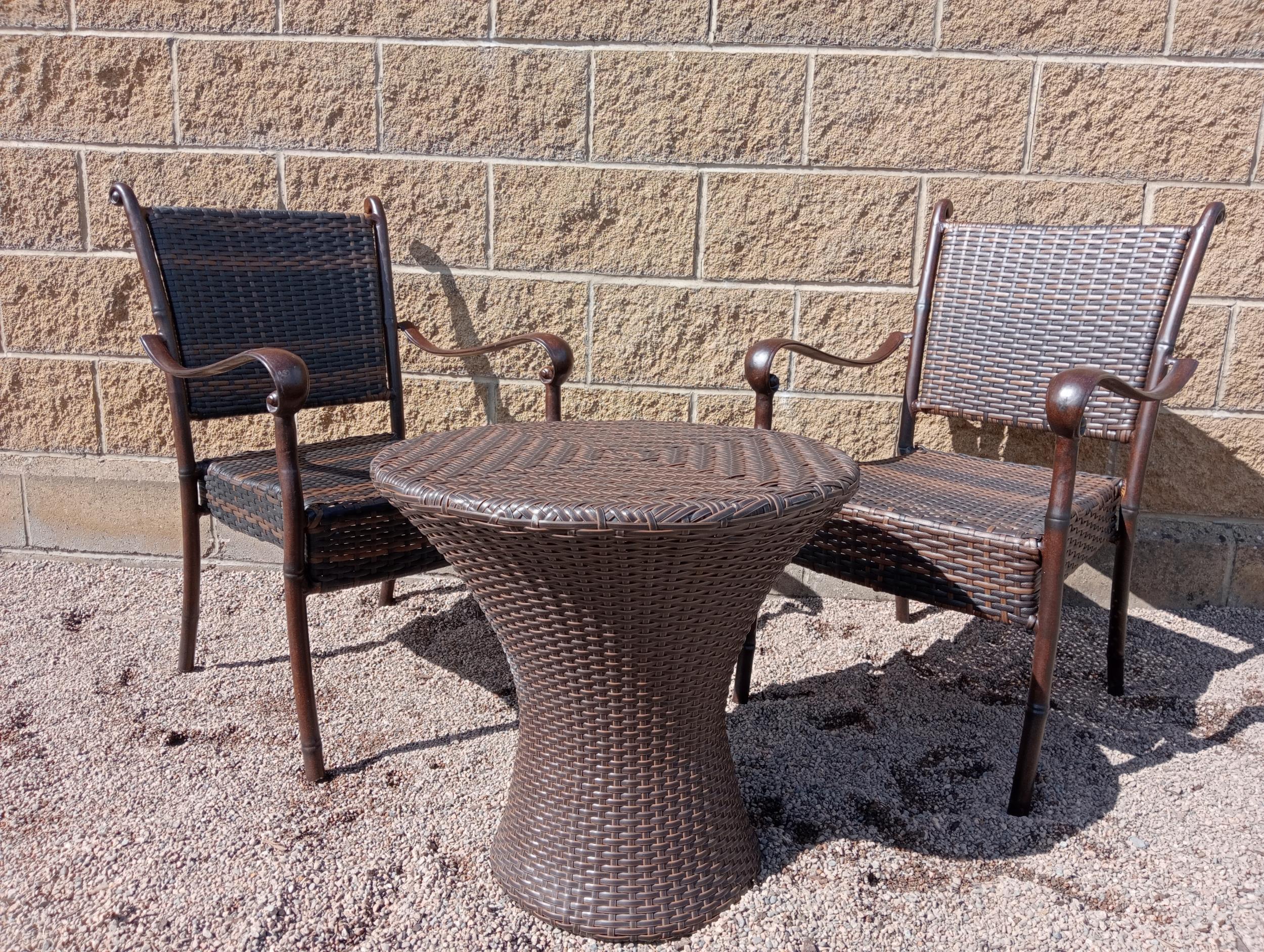 Rattan garden table and two chairs {Table H 56cm x Dia 60cm Chairs H 86cm x W 57cm x D 52cm }. (