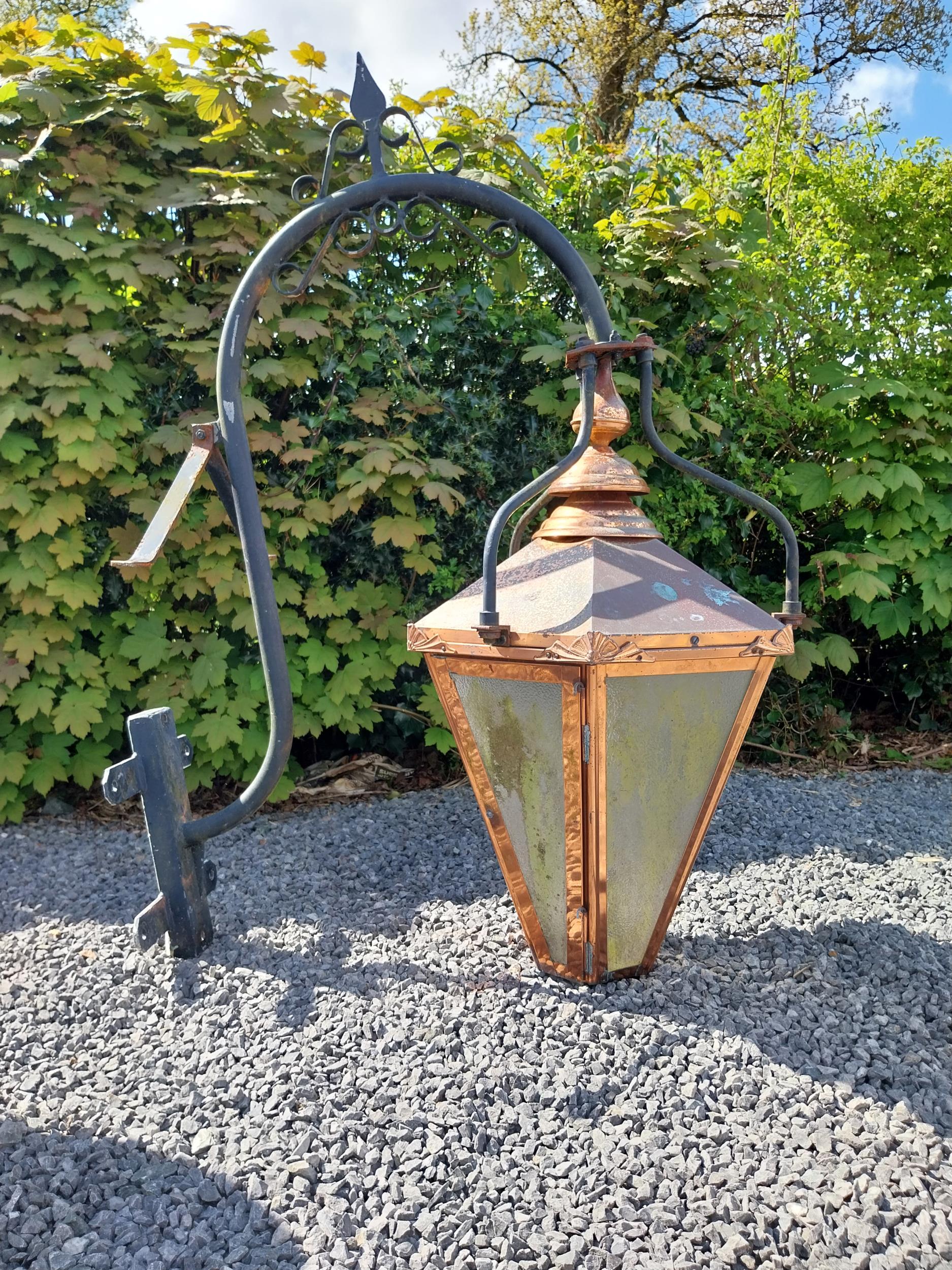 Good quality copper wall lantern with wrought iron bracket {129 cm H x 94 cm W x 54 cm D}.