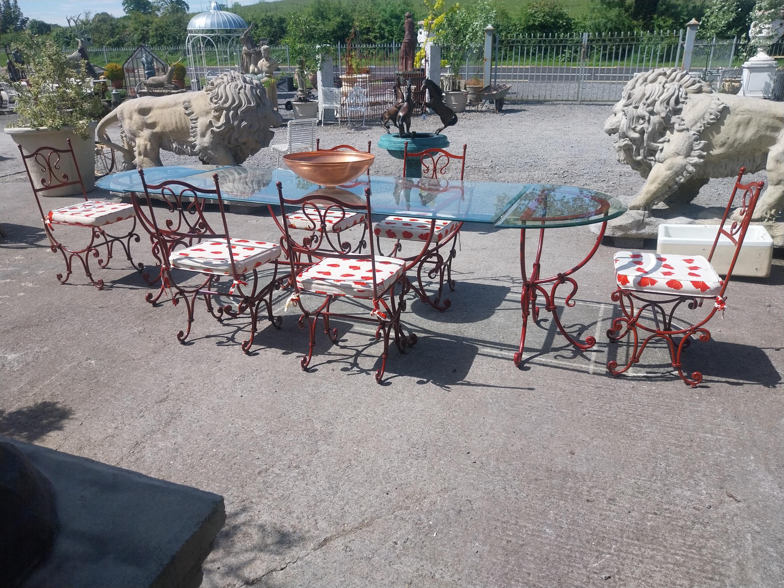 Good quality wrought iron garden table with glass top and detachable d-ends and six matching