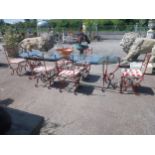 Good quality wrought iron garden table with glass top and detachable d-ends and six matching