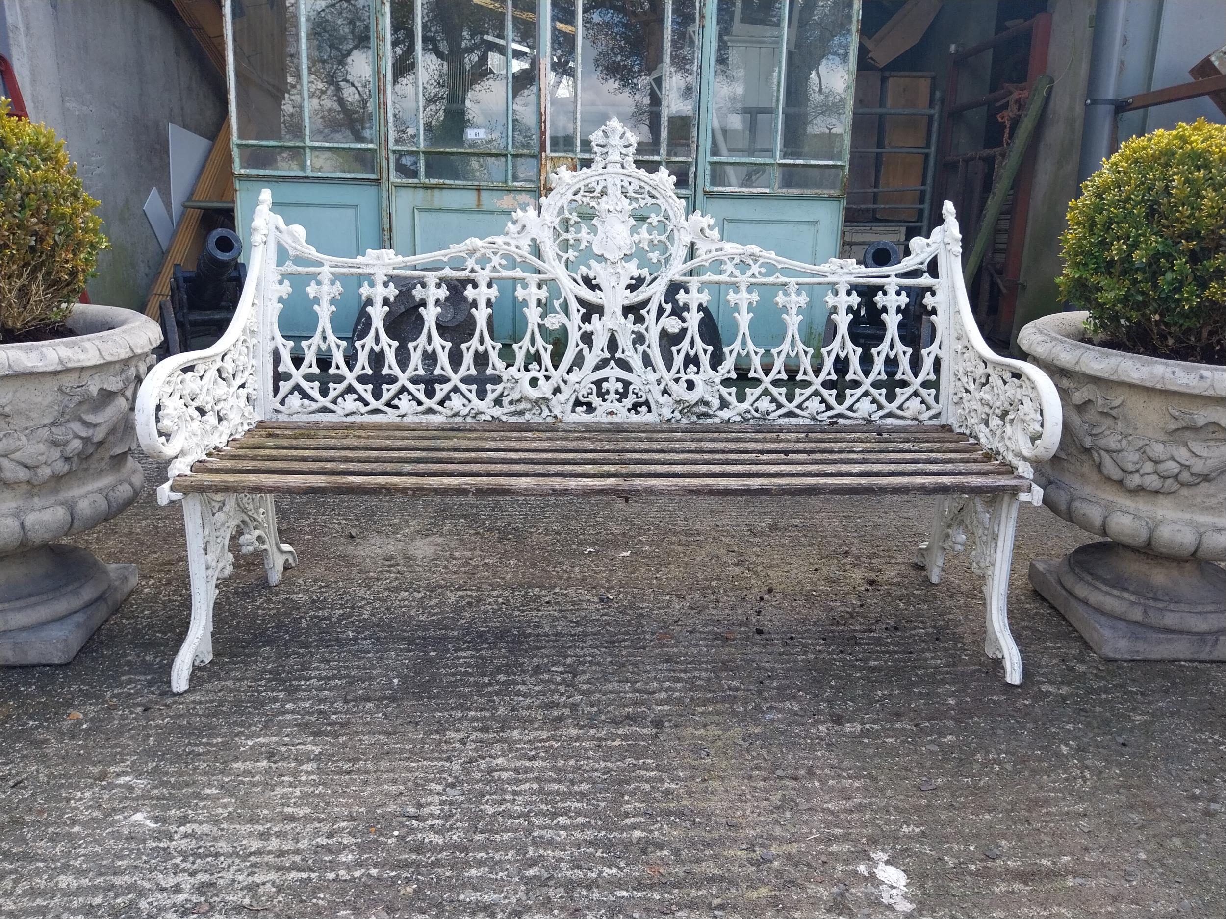 Decorative cast alloy garden bench in the Victorian style {99 cm H x 150 cm W x 68 cm D}.