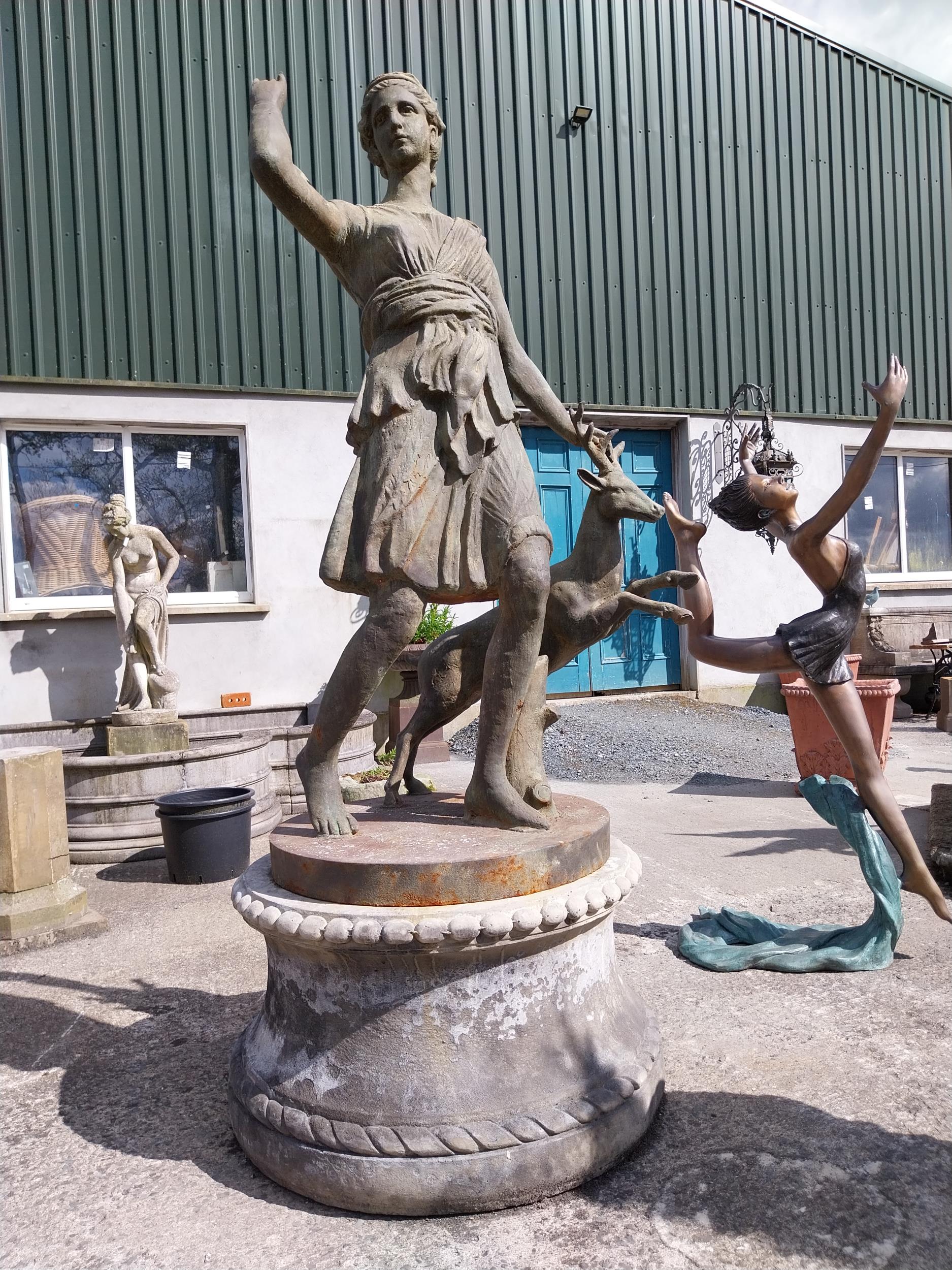 Good quality cast iron life-size statue of The Huntress raised on composition pedestal {240 cm H x