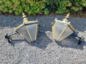 Pair of brass wall lanterns with wrought iron brackets {79 cm H x 83 cm W x 60 cm D}.