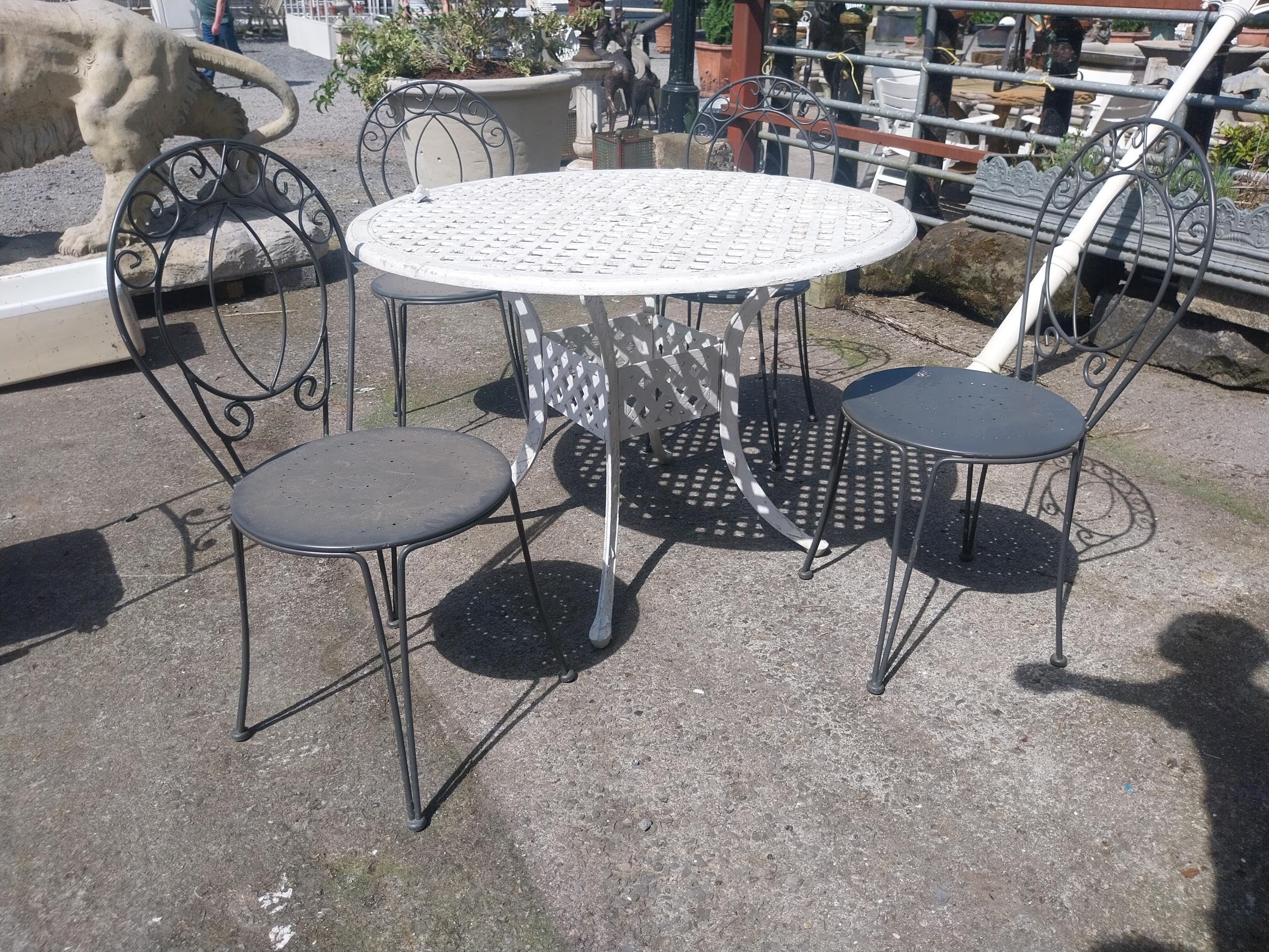 Cast iron aluminium garden table and four wrought iron garden chairs {Tbl. 73 cm H x 106 cm Dia. and