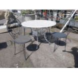 Cast iron aluminium garden table and four wrought iron garden chairs {Tbl. 73 cm H x 106 cm Dia. and