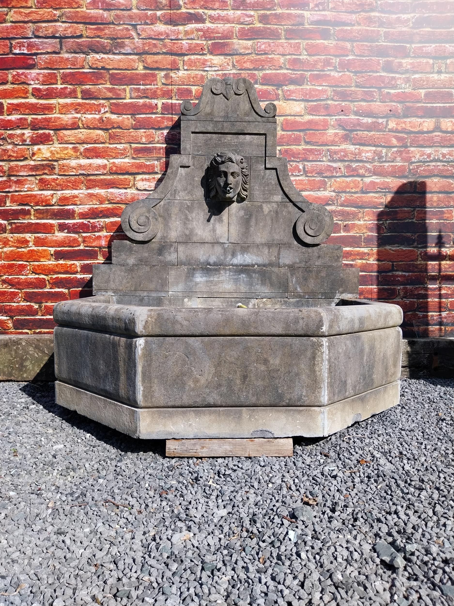 Hand carved limestone wall fountain decorated with Ladies mask {172 cm H x 156 cm W x 127 cm D}.